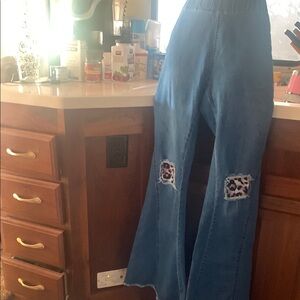 Blue Flare Jeans with Distressed Knees and Decorative Patches